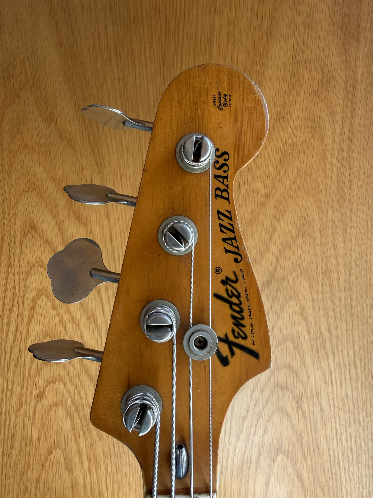 The headstock of David's 1975 Fender Jazz Bass, worn tuners and the original logo