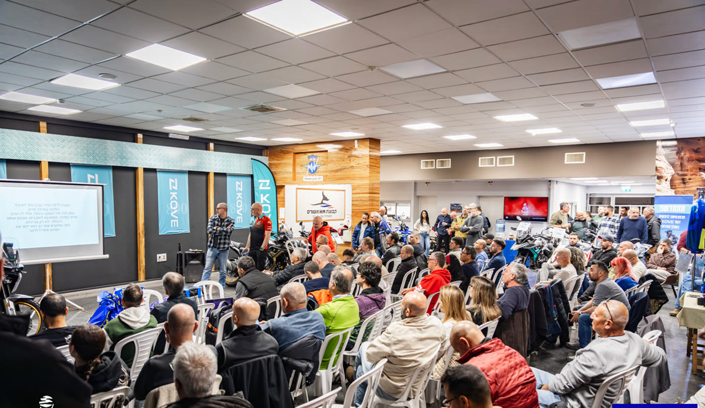 The full room at the KOVE lecture, riders seated, David presenting by the screen