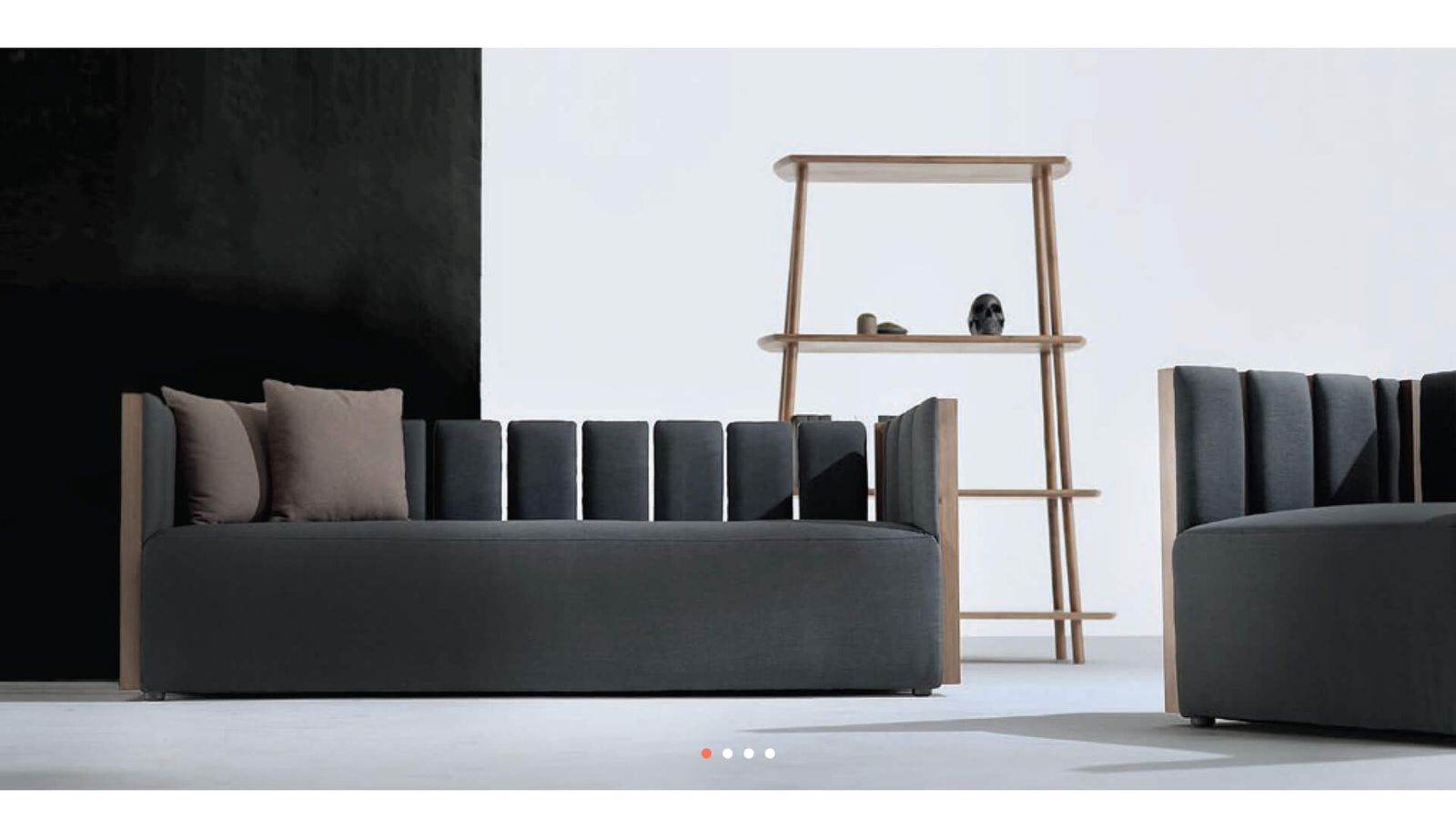 Neospeq upholstered sofas and a wooden shelf in a dark showroom